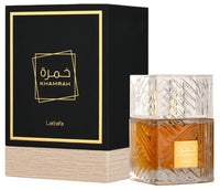 A square-shaped glass bottle of Lattafa Perfume Khamrah Eau de Parfum 100ml with a gold and black label, displayed alongside its packaging box.